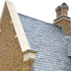 Acanthus cast stone coping stones on a roof gable