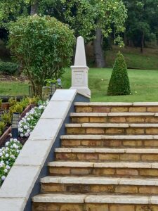 cast stone obelix in garden on steps 