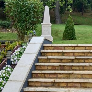 cast stone obelix in garden on steps